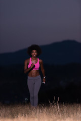 Image showing Young African american woman jogging in nature