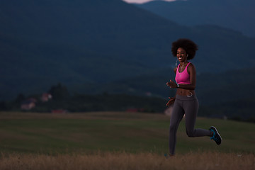 Image showing Young African american woman jogging in nature