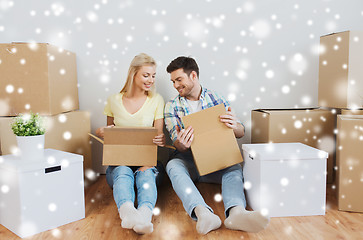 Image showing smiling couple with many boxes moving to new home