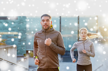 Image showing happy couple of sportsmen running upstairs in city