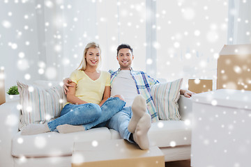 Image showing happy couple with big cardboard boxes at new home