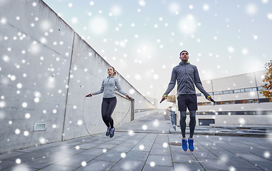 Image showing man and woman exercising with jump-rope outdoors