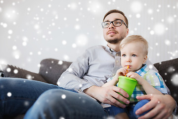 Image showing father and little son drinking from cup at home