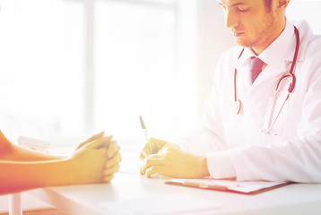 Image showing patient and doctor taking notes