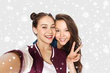 Image showing happy friends taking selfie and showing peace