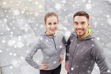 Image showing happy couple of sportsmen outdoors on city street