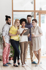 Image showing creative team with tablet pc and coffee at office