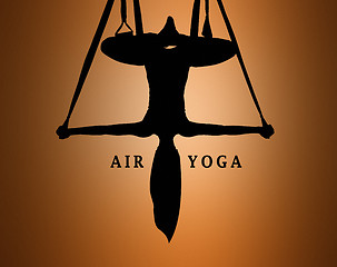 Image showing The silhouette of Young woman doing anti-gravity aerial yoga