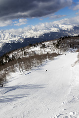 Image showing Skiers on ski slope at sun winter day