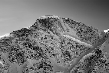 Image showing Black and white view on mountains with snow in winter sun evenin