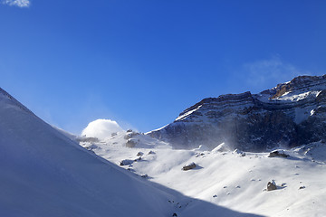 Image showing Off-piste slope during blizzard and sunlight blue sky