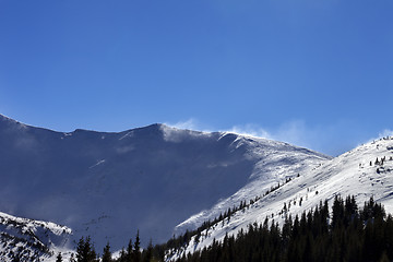 Image showing Winter snow mountains at sunny windy day