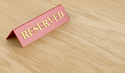 Image showing Reserved sign on table 