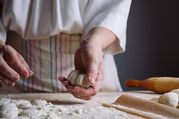 Image showing Two hands making dough for meat dumplings.