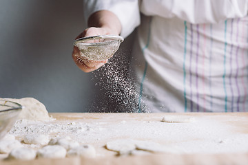 Image showing Two hands making dough for meat dumplings.