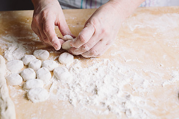 Image showing Two hands making dough for meat dumplings.