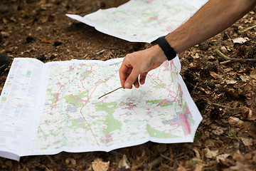 Image showing Navigating with map and compass