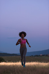 Image showing Young African american woman jogging in nature