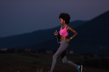 Image showing Young African american woman jogging in nature