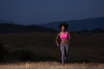 Image showing Young African american woman jogging in nature