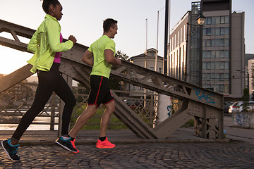 Image showing young multiethnic couple jogging in the city