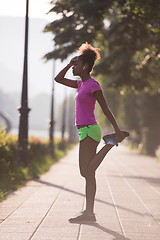 Image showing Black woman doing warming up and stretching