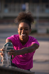 Image showing African American woman doing warming up and stretching