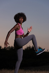 Image showing black woman is doing stretching exercise relaxing and warm up