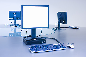 Image showing Three computers on desktop