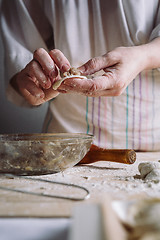 Image showing Two hands making meat dumplings.