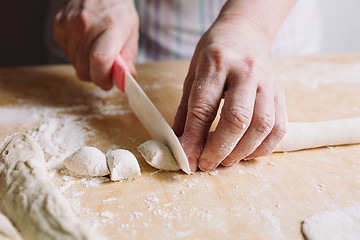 Image showing Two hands making dough for meat dumplings.