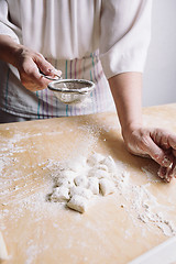 Image showing Two hands making dough for meat dumplings.