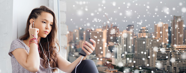 Image showing teenage girl with smartphone and earphones