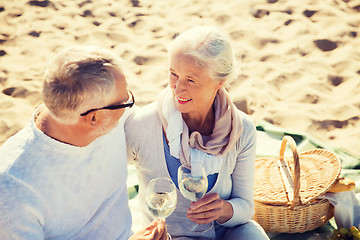 Image showing happy senior couple talking on summer beach