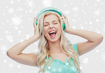 Image showing happy young woman or teenage girl with headphones