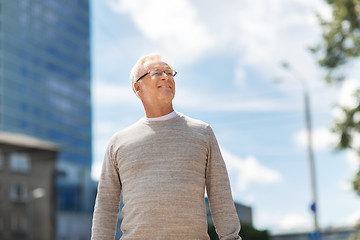 Image showing senior man walking along summer city street