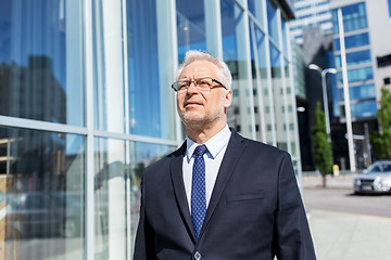 Image showing senior businessman on city street