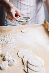 Image showing Two hands making dough for meat dumplings.