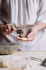 Image showing Two hands making meat dumplings.