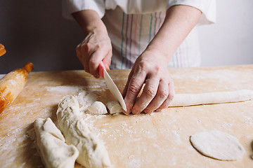 Image showing Two hands making dough for meat dumplings.