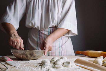 Image showing Two hands making meat dumplings.