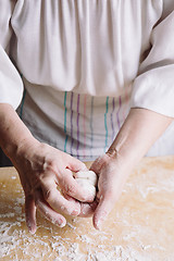 Image showing Two hands making meat dumplings.