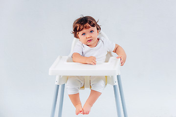 Image showing Happy baby boy sitting on studio background