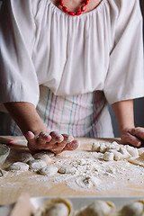 Image showing Two hands making dough for meat dumplings.