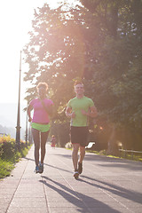 Image showing young multiethnic couple jogging in the city