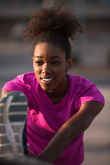 Image showing African American woman doing warming up and stretching