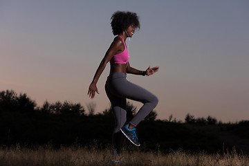 Image showing black woman is doing stretching exercise relaxing and warm up