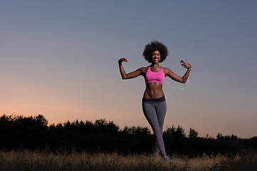 Image showing black woman is doing stretching exercise relaxing and warm up