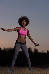 Image showing black woman is doing stretching exercise relaxing and warm up