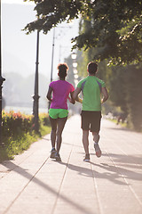 Image showing young multiethnic couple jogging in the city